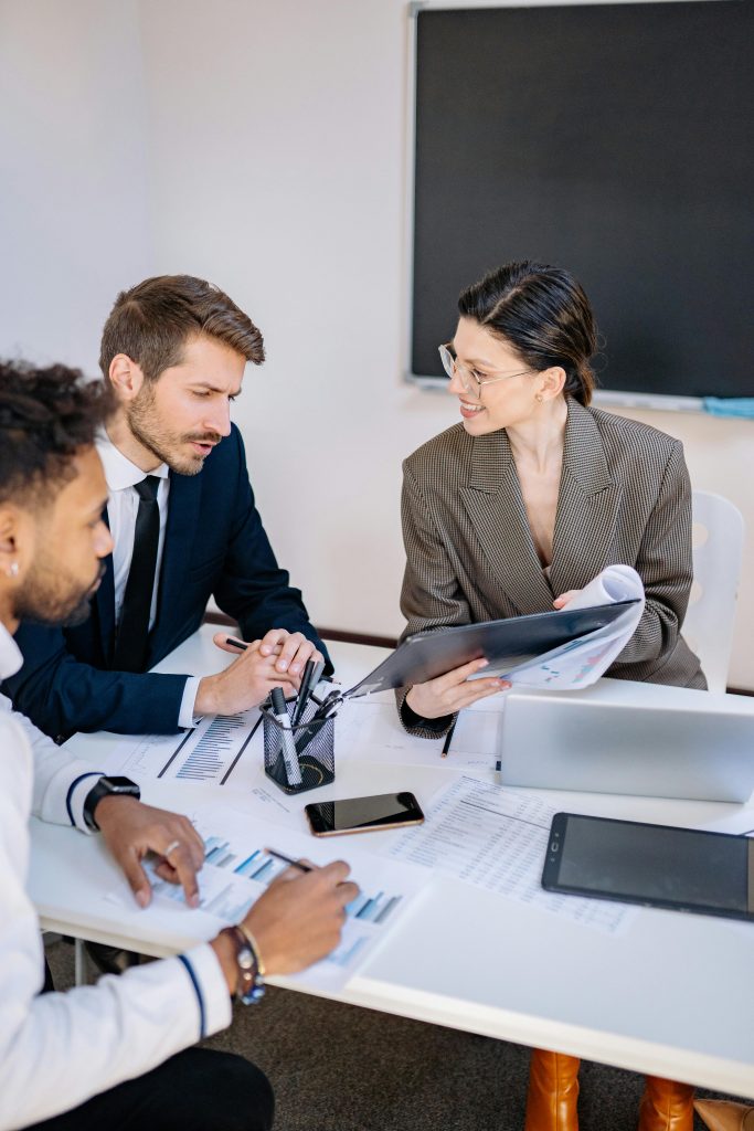business people in office reviewing notes
